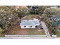 Cozy single story home with mature trees in a charming neighborhood with a large backyard and white picket fence at 2832 W Bay Haven Dr, Tampa, FL 33611
