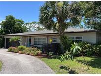 Charming single-story home featuring a lush, landscaped front yard and a welcoming exterior at 4100 Narvarez S Way, St Petersburg, FL 33712