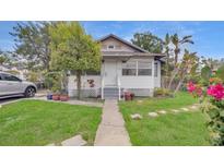Charming single-Gathering home features a well-maintained lawn and cozy porch at 4804 N 10Th St, Tampa, FL 33603