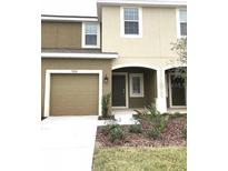 Two story home with a two car garage, neutral paint and landscaping at 7060 Woodchase Glen Dr, Riverview, FL 33578