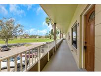 Hallway view of unit 7 with beautiful landscaping and view of open recreational space at 2403 Finlandia Ln # 27, Clearwater, FL 33763