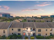 Charming townhomes boast well-maintained lawns and inviting architecture at 2462 Kingfisher Ln # J203, Clearwater, FL 33762