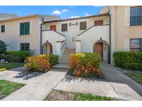 Inviting townhome entrance featuring dual staircases and arched doorways at 2462 Kingfisher Ln # J203, Clearwater, FL 33762