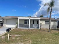 Charming single-story home with a well-maintained front yard and attached garage at 3641 Dickens Dr, Holiday, FL 34691