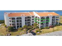 Stunning waterfront condo with lush landscaping and classic Mediterranean architecture, offering serene coastal living at 438 Mariner Dr, Tarpon Springs, FL 34689