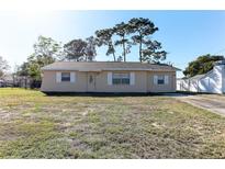 Charming single-story home featuring a well-maintained lawn, white shutters, and a welcoming front entrance at 5155 Kenmore St, Spring Hill, FL 34608
