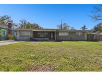 Charming single story home with a spacious lawn and a screened-in front porch at 200 W Louisiana Ave, Tampa, FL 33603
