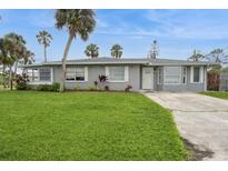 Charming single-story home with a well-manicured lawn, complemented by palm trees for a tropical touch at 112 Rose St, Venice, FL 34293