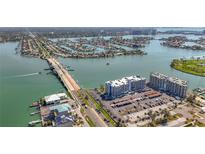 Aerial view showcasing condo buildings next to the water, featuring a nearby bridge at 500 Treasure Island Cswy # 207, Treasure Island, FL 33706