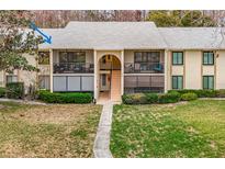 Inviting condo showcasing well-maintained landscaping, dual balconies, and serene curb appeal at 1354 Shady Pine Way # E2, Tarpon Springs, FL 34688