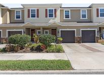 Charming townhome with manicured landscaping, attached garages, and inviting curb appeal at 1308 Syrah Dr, Oldsmar, FL 34677