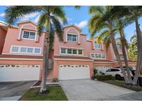 Charming townhouse featuring a two-car garage and well-maintained landscaping in a desirable neighborhood at 14584 El Paseo Dr, Seminole, FL 33776