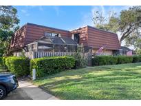 Charming townhome with well-manicured lawn, screened patio, and American flags waving at 2612 6Th Ct, Palm Harbor, FL 34684