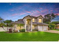 Stunning two-story home featuring a well-manicured lawn and a three-car garage, perfect for a growing Gathering at 3018 N 164Th Pl, Clearwater, FL 33760