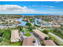 Panoramic aerial view of waterfront homes, canals, and community near the ocean under blue sky at 4570 Overlook Ne Dr # 282, St Petersburg, FL 33703