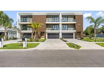 Modern townhomes with a contemporary design featuring private balconies and attached garages at 101 W Warren Ave # 1, Tampa, FL 33602