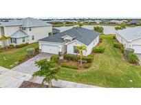 Charming one-story home with well-manicured landscaping and a two-car garage near a lake at 17541 Corkwood Bend Trl, Punta Gorda, FL 33982