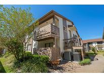 Two-story condo building featuring dual balconies, lush landscaping, and a fresh, modern color scheme at 2364 Flanders Way # 41-D, Safety Harbor, FL 34695
