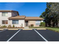Charming single-story condo with assigned parking and well-maintained landscaping at 3857 Sailmaker Ln, Holiday, FL 34691