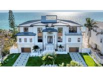Stunning beachfront home with modern design, lush landscaping, and direct ocean views at 4005 Casey Key Rd, Nokomis, FL 34275