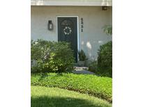 Inviting front entrance with dark door, white trim and floral wreath, surrounded by manicured landscaping at 5231 Bayshore Blvd # 10, Tampa, FL 33611