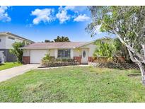 Charming single-story home featuring a well-maintained lawn and a cozy, inviting facade at 5510 Berlin Dr, Port Richey, FL 34668