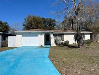 Charming single-story home with attached garage and blue driveway at 6107 Montana Ave, New Port Richey, FL 34653