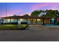 Charming single-story home featuring brick facade, well-manicured lawn and convenient covered parking at 7213 Trinity Pl, Tampa, FL 33610