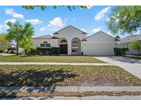 Charming single-story home featuring a well-manicured lawn and traditional architectural details at 11611 Jordans Landing Ct, Riverview, FL 33569