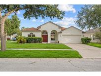 Inviting single-story home featuring a manicured lawn and a charming facade at 11611 Jordans Landing Ct, Riverview, FL 33569