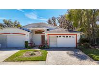 Charming single Gathering home with a well-manicured lawn and brick driveway, perfect for suburban living at 13542 Norman Cir, Hudson, FL 34669
