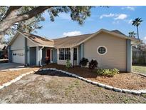 Charming single Gathering home featuring a 1-car garage, well-maintained front yard with lovely landscaping at 1425 Monte Lake Dr, Valrico, FL 33596