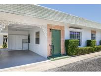 Charming home featuring a covered carport with laundry and decorative trim, complemented by well-maintained landscaping at 7847 39Th N Ter, St Petersburg, FL 33709