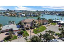 Stunning aerial view of waterfront home with lush landscaping, boat dock, and panoramic views of the bay at 7986 9Th S Ave, St Petersburg, FL 33707