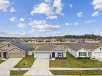 Charming single-story home features a well-maintained lawn and inviting curb appeal on a sunny day at 8034 Broad Pointe Dr, Zephyrhills, FL 33540