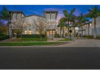 Beautiful modern townhome with manicured lawn and tall palm trees lining the street at 1110 25Th N St, St Petersburg, FL 33713