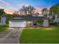 Charming single-story home with a well-manicured lawn, landscaping, and a two-car garage at 2745 Horseshoe Dr, Plant City, FL 33566