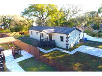 Charming home featuring a landscaped yard, paved walkway and driveway, and a classic, neutral color scheme at 3012 E 149Th Ave, Lutz, FL 33559