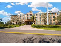 Beautiful four story condo building with paved entrance and attractive landscaping at 4221 W Spruce St # 1123, Tampa, FL 33607