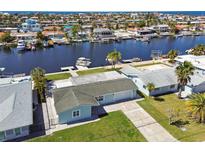 Waterfront home boasts lush landscaping, boat dock, and canal access to the ocean at 5321 Bowline Bnd, New Port Richey, FL 34652