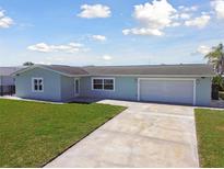 Charming single-story home featuring a well-maintained lawn and attached garage, perfect for suburban living at 5321 Bowline Bnd, New Port Richey, FL 34652