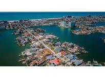 Gorgeous aerial view of the home nestled in a charming waterfront neighborhood at 5815 Bali S Way, St Pete Beach, FL 33706