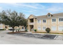 Inviting multi-Gathering home features a beige stucco exterior, dormer windows and well-maintained landscaping at 6434 Cypressdale Dr # 102, Riverview, FL 33578