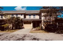 Charming townhome with a one-car garage, neutral siding, and well-maintained front yard at 8010 Bally Money Rd, Tampa, FL 33610