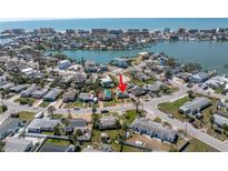 An aerial view shows the beautiful waterfront community with various buildings and calm waters at 14066 Marguerite Dr, Madeira Beach, FL 33708