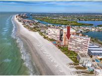 Aerial view of beachfront condo property with pool and stunning water views on a sunny day at 17920 Gulf Blvd # 702, Redington Shores, FL 33708