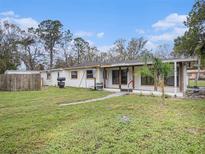 Charming single-story home with a covered porch and a spacious front yard at 18108 Crooked Ln, Lutz, FL 33548