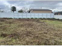 Picture of a vacant lot surrounded by a white fence and foliage at 4104 W Osborne Ave, Tampa, FL 33614
