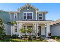 Charming two-story home with a covered front porch and beautiful landscaping, creating great curb appeal at 7266 Kodiak Ln, Sarasota, FL 34240