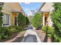 Charming townhome exterior with well-maintained landscaping and a welcoming walkway at 10814 Brickside Ct, Riverview, FL 33579